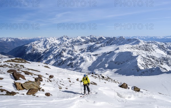 Ski tourers ascending Monte Cevedale, mountain panorama, snow-covered mountain landscape in winter,
