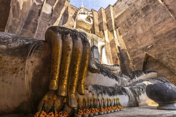 Giant Buddha statue in the temple Wat Si Chum, UNESCO World Heritage Sukhothai Historical Park,