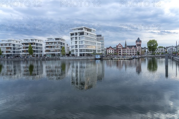 The Hörder Castle and modern office buildings on Lake Phoenix in Dortmund, North Rhine-Westphalia,
