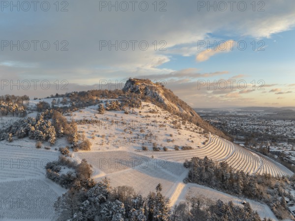 Aerial view of the snow-covered Hegau volcano Hohentwiel with Germany's largest castle ruins on a