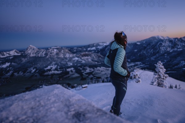 Hiking in the snow in the snow-covered winder landscape in the Alps at Neunerköpfle in the