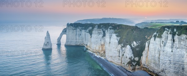The coast of Etretat (Étretat) at sunrise, cliffs with Porte d'Aval and Aiguille rock needle,