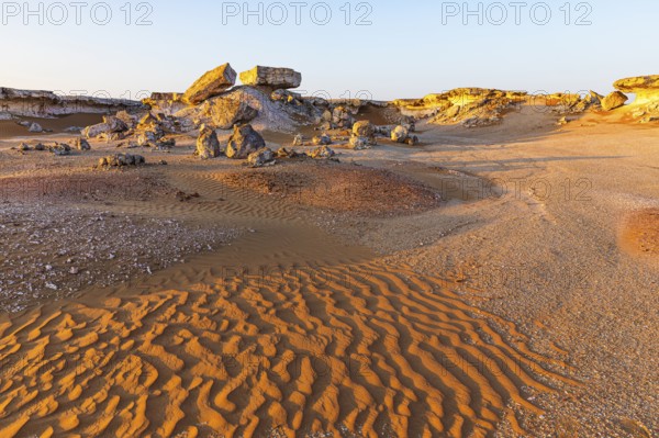 Striking cliffs surrounded by windswept sand structures, Huqf stone desert, Arabian Peninsula,