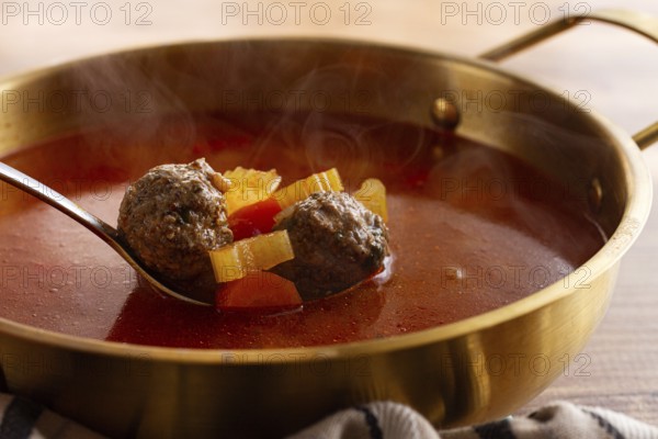 Romanian soup with meatballs, vegetable soup with meatballs, in a pot, homemade, no people