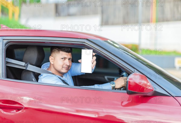 Smiling male driver showing cell phone screen. Handsome driver showing cell phone screen outdoors