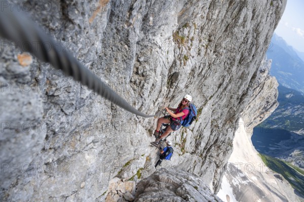 Mountaineer with helmet climbing in a secured via ferrata, Zugspitz via ferrata, ascent to the