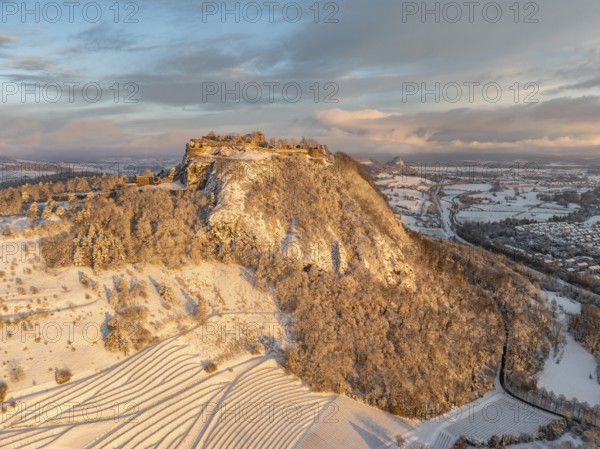 Aerial view of the snow-covered Hegau volcano Hohentwiel with Germany's largest castle ruins on a