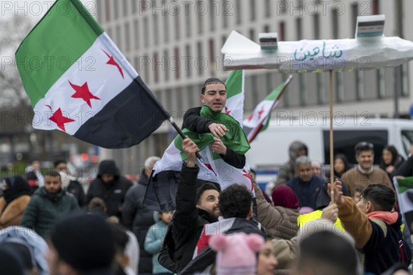People celebrate the end of the Assad regime after the change of power in Syria at a rally on the