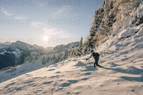 Hiking in the snow in the snow-covered winder landscape in the Alps at Neunerköpfle in the