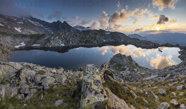 Mountain lake reflecting the sky during sunset over rocky landscape, Krimml, Salzburg, Austria,