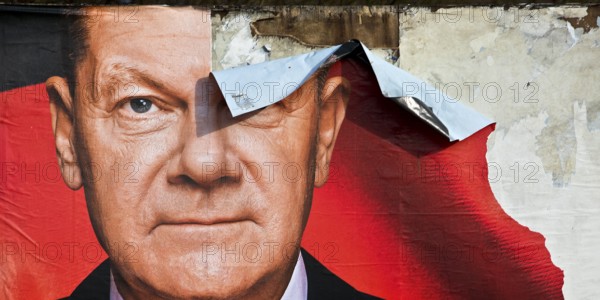 Partially destroyed large poster for the 2025 federal election by the SPD with Olaf Scholz, Witten,