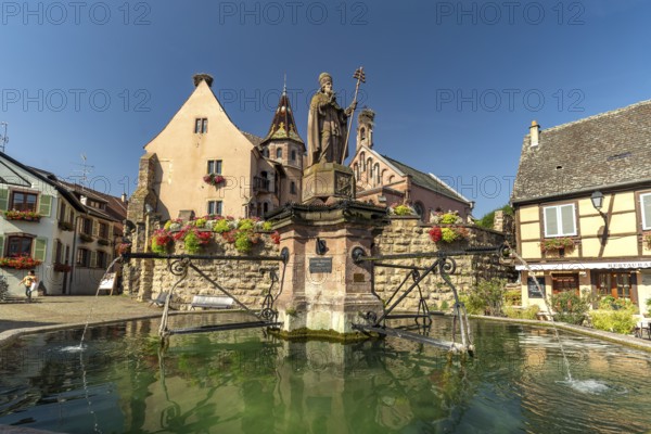 Fountain Fontaine de Saint-Léon and St Leo's Chapel in Eguisheim, Alsace, France, Europe