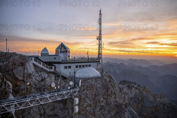Mountain station of the Tyrolean Zugspitze railway at the summit of the Zugspitze, at sunset,