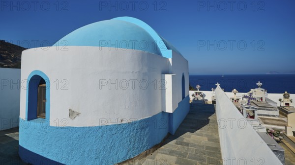 Small chapel in blue and white next to a cemetery with sea view, Pali village, Pali, Volcanic