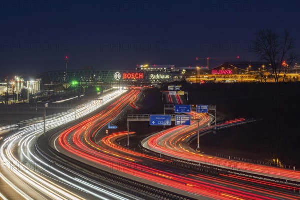 A8 motorway at Stuttgart Airport in the evening. Heavy traffic, lanes of light. Modern architecture