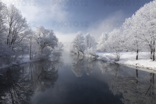 Lake Kochelsee in Bavaria, Germany. River Loisach leaving the lake. Winter, hoar frosted trees