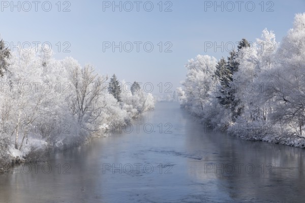 Lake Kochelsee in Bavaria, Germany. River Loisach leaving the lake. Winter, hoar frosted trees