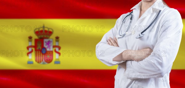 Doctor with crossed arms on Spain flag. Spain Health and Care concept. Female doctor on Spain flag