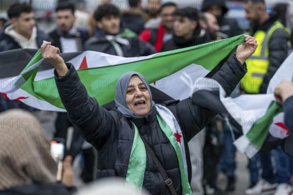 Syrian woman celebrate the end of the Assad regime after the change of power in Syria at a rally on