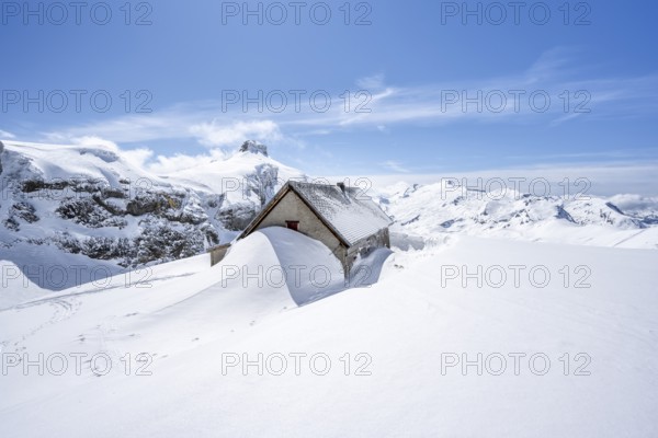 Snow-covered hut in winter, mountain landscape with snow, behind summit Rohrbachstein and Wildhorn,