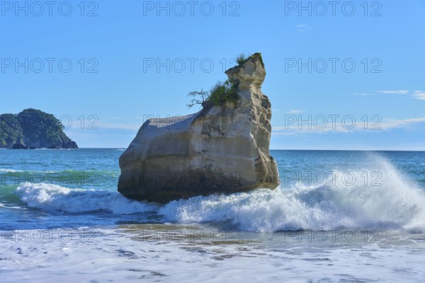Energetic waves crash against a huge rock in the sea, Cathedral Cove, Hahei, Coromandel Peninsula,