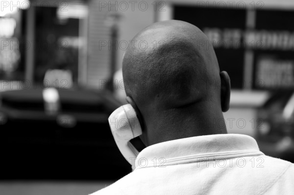 Coloured New Yorker talking on a street phone, New York City, USA, North America