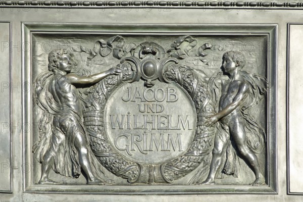 Relief on the Brothers Grimm National Monument, Jacob and Wilhelm with laurel wreath, inscription,