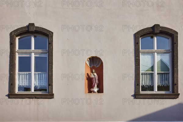 Historic building, facades with windows and house Madonna, Mesenich, district of Cochem-Zell,