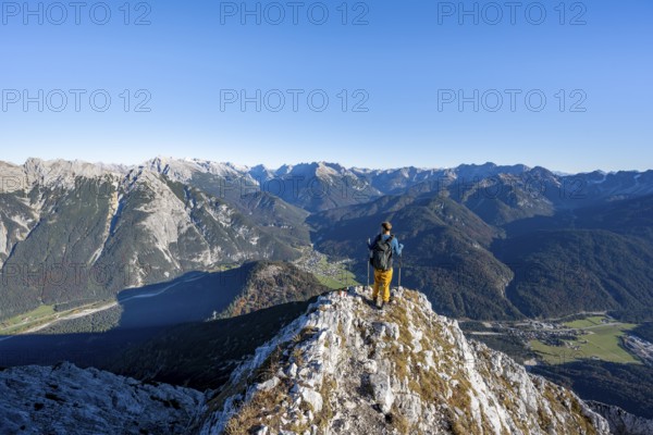 Mountaineer at the summit of the Große Arnspitze, mountain panorama with Karwendel mountains,