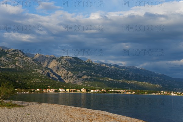 Coastline with mountains in the background under a cloudy sky, Starigrad, Starigrad-Paklenica,