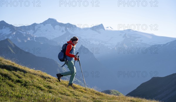 Hiker enjoying the mountain panorama in the morning, Venediger group, behind Dreiherrenkopf,