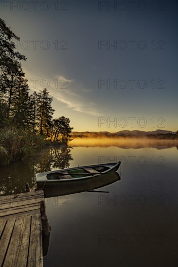 Boats in the autumnal Schmutter Weiher in the Allgäu near the municipalities of Halblech,