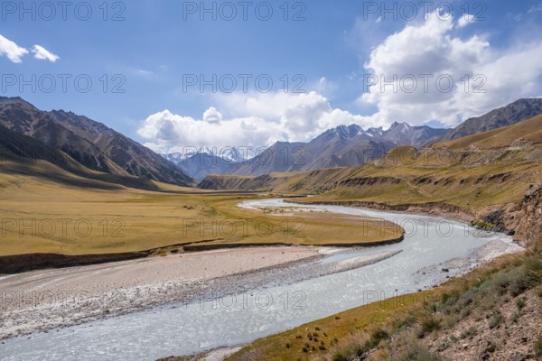 Mountain river in a valley, picturesque mountain landscape with white mountain peaks, Tian Shan