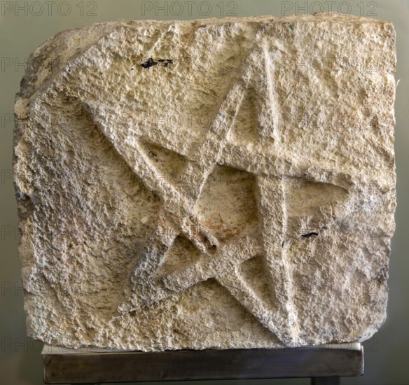 Five point star inscribed in stone, from Kutza, Late classic period, Mayan archaeological museum,