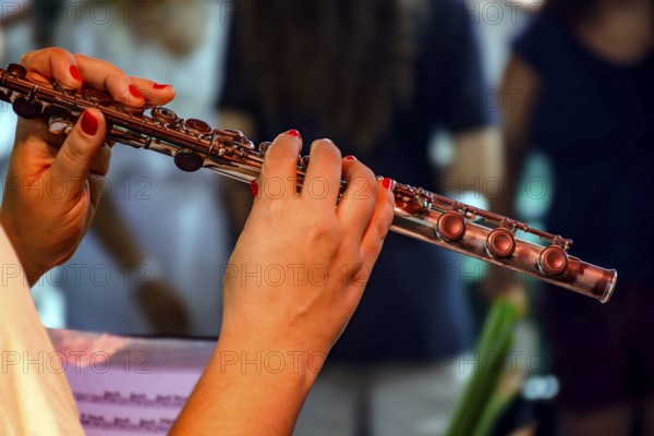 Woman's hands playing transverse flute during musical performance Belo Horizonte, Minas Gerais,