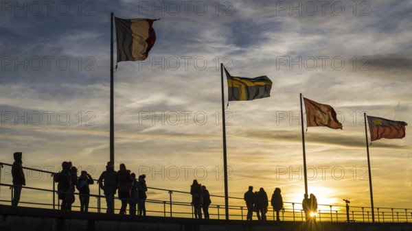 People, silhouettes, flags, harbour in Lindau on Lake Constance, Bavaria, Germany, Europe