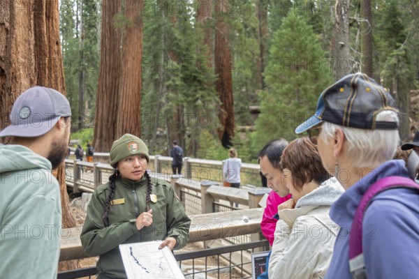 Yosemite National Park, California - A National Park Service worker talks to visitors at the