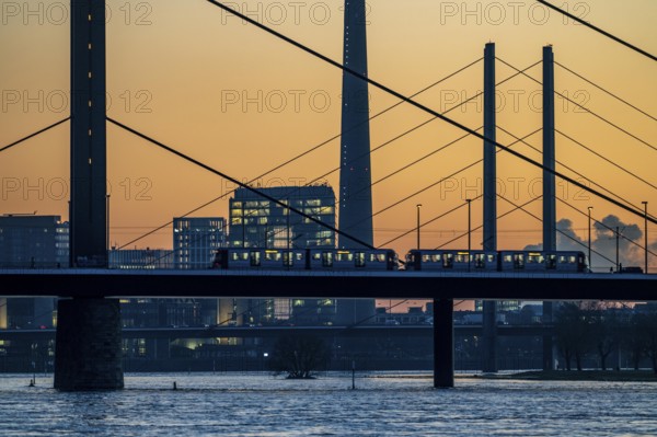 Sunset on the Rhine near Düsseldorf, skyline of the city centre with Rhine Tower, Rheinkniebrücke,