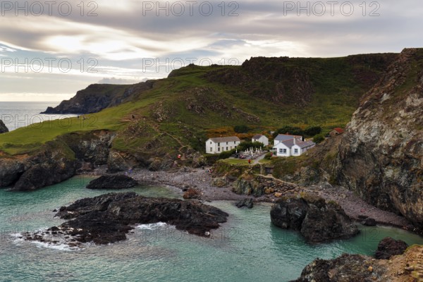 Restaurant, café in a former fisherman's hut in a remote bay, rocky coast at Kynance Cove, evening