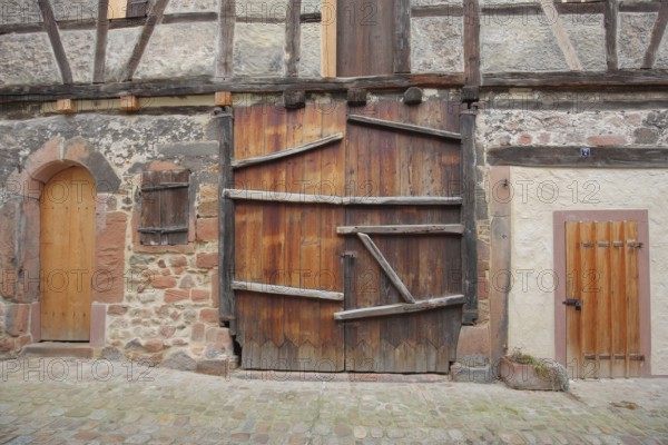 House wall with gates and doors, historic building, wooden construction, beams, wooden gate,