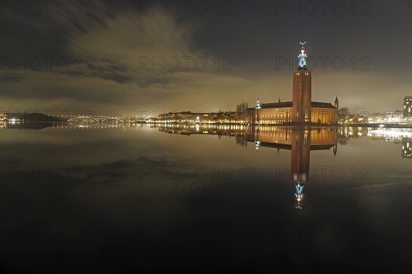 Night city view with illuminated tower and bridges in the background, winter, ice, capital, city