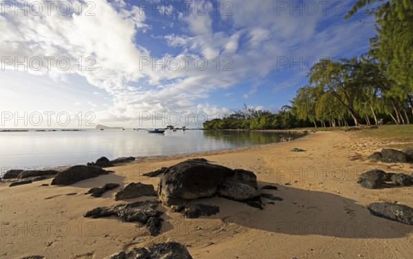 Golden sandy beach on the Indian Ocean near Calodyne, with Gunner's Coin Island in the background,