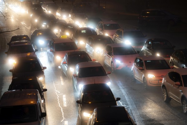 Dense fog, with visibility sometimes less than 100 metres, city centre traffic during rush hour at