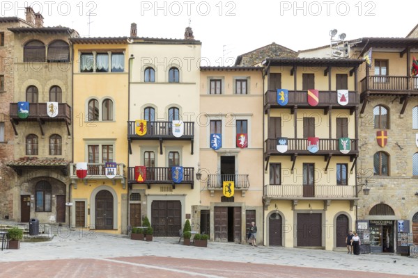 Piazza Grande with houses from different eras with wooden balconies and coats of arms, Arezzo,