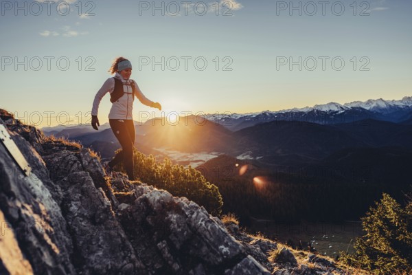 Trail running in autumn on the Jochberg on Lake Walchensee against the wonderful backdrop of the