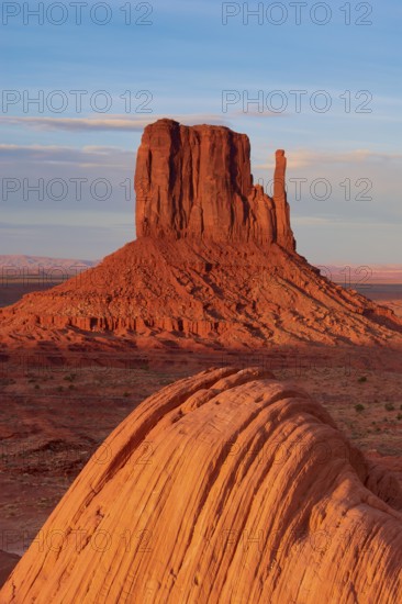Monument Valley with majestic red sandstone formations in the desert under a clear sky in sunlight,