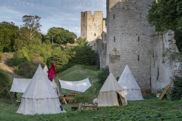 Camp in front of historic city walls with defence towers, Medieval Week, Hanseatic City of Visby,
