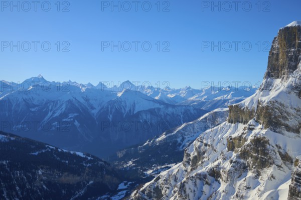 Snowy mountain landscape with clear blue sky and rocky peaks in alpine surroundings, Gemmi Pass,