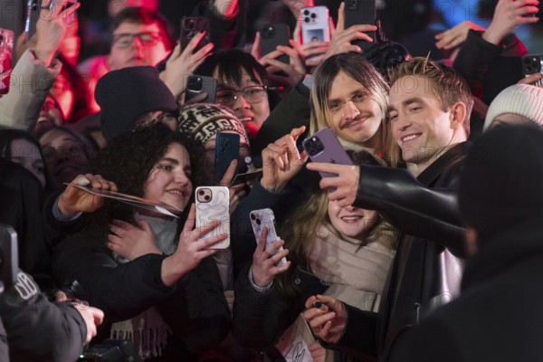 Robert Pattinson takes selfies with fans on the red carpet at the Special Gala of the film Mickey