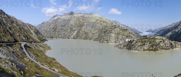 Grimselsee or Lake Grimsel with the historical Hotel Grimsel Hospiz near the Grimsel Pass in the